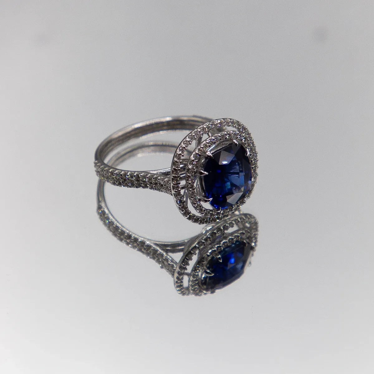 18k White Gold Halo/ Intense Blue Sapphire 6.39 Carats/ 132 Diamonds 0.66 Cts